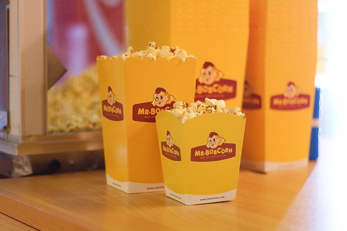Popcorn in a yellow serving boxes.